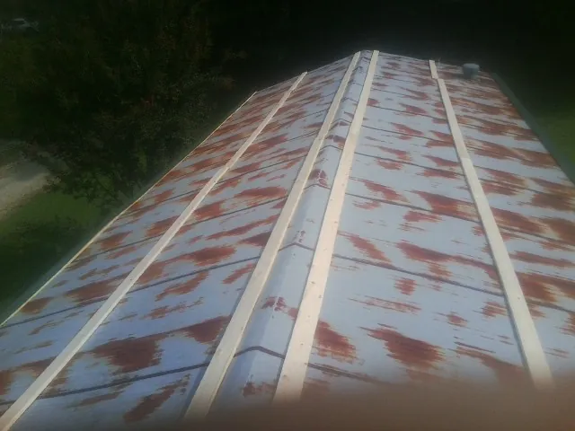 Rusted metal roof panels with new wood purlins before replacement — Storm Damage Roof Repair in Platina by Roofing Brothers
